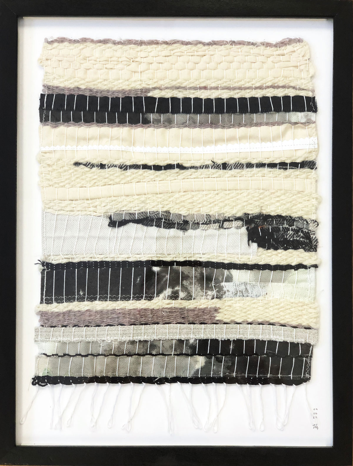 A framed scrap weaving by Liz Broekhuyse