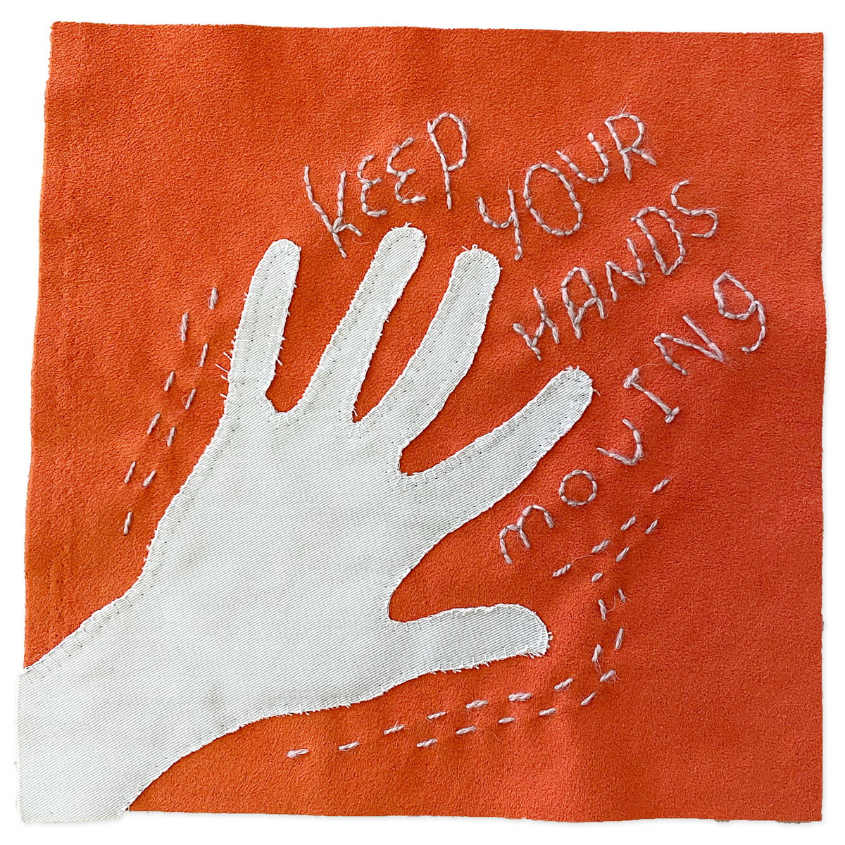 A square of orange fabric with a beight hand-shaped piece of fabric embellished on top. stitching reads 'keep your hands moving'. Part of the Textile Upcycling Manifesto by Liz Broekhuyse